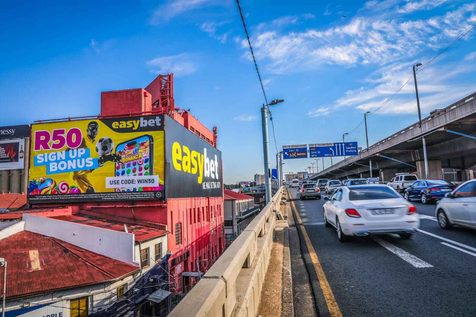 Easybet billboard printed on PVC beside a freeway