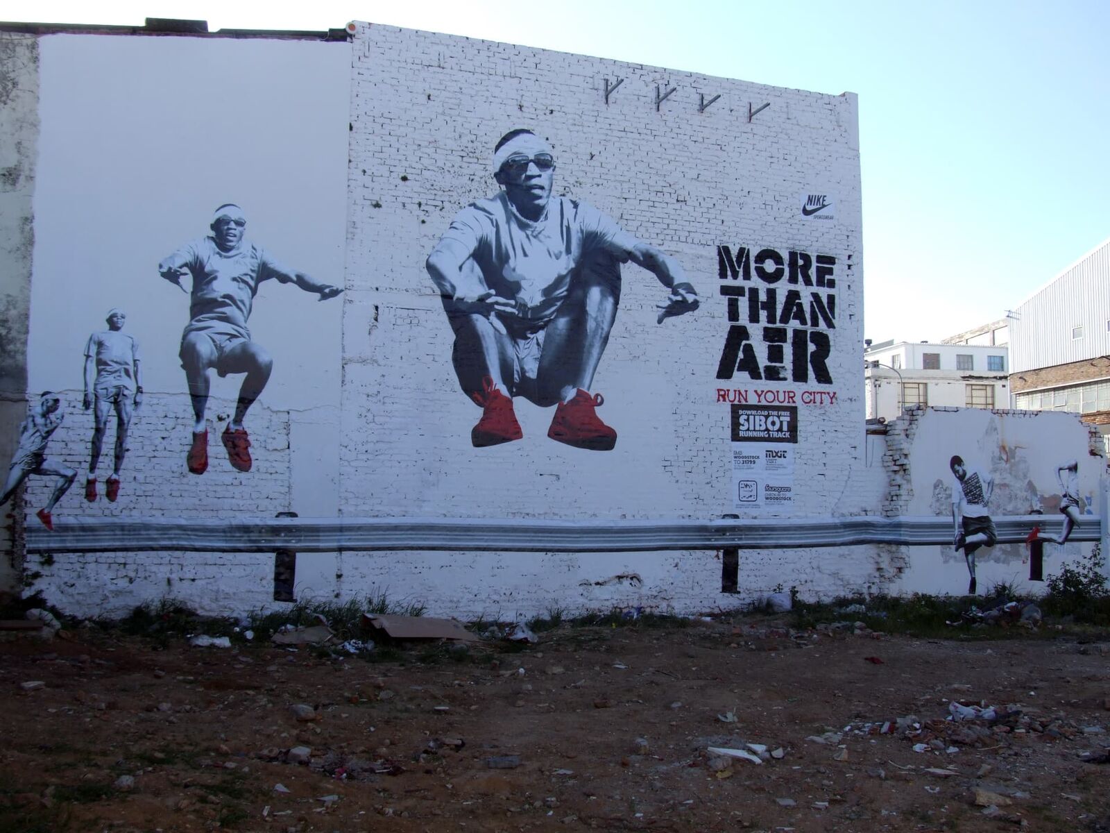 Nike More Than Air printed wall graphic covering a brick building facade